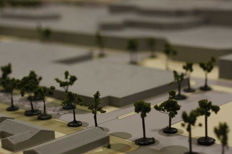 A site model with grey scale models of residential homes with gable roofs
